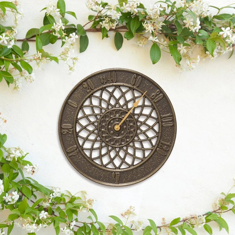 Whitehall Spiral thermometer displayed on a white garden wall with flowering vines