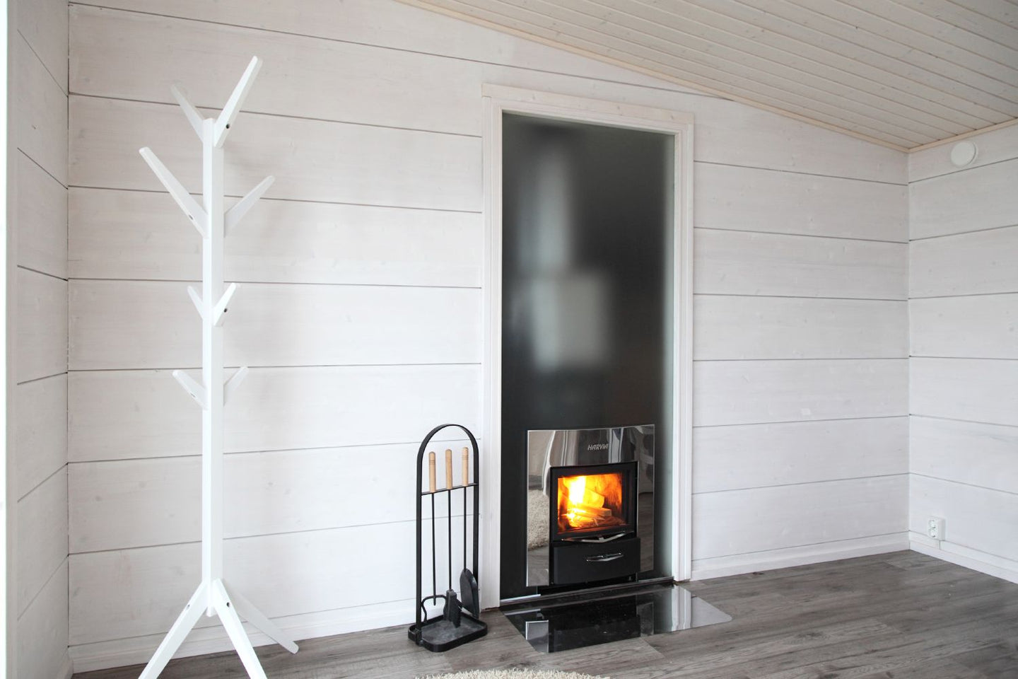 Harvia Pro Duo wood-burning heater and glass wall installation